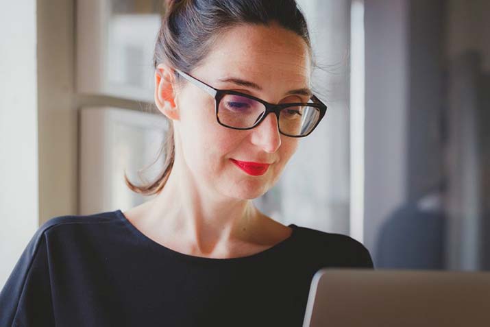 female-with-glasses-working